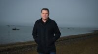 Tony Cottee, pictured on Southend seafront, is still a West Ham season-ticket holder