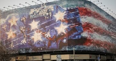 A billboard depicting a damaged US aircraft carrier with disabled fighter jets on its deck and a sign reading in Farsi and English, 'If you sow the wind, you'll reap the whirlwind,' is seen at Enqelab-e-Eslami (Islamic Revolution) Square in Tehran, Iran, Sunday, January 25