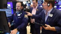 Traders work on the floor of the New York Stock Exchange as fresh data showed U.S job growth slowed in December, fueling fears the economy may be losing momentum