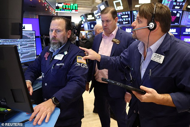 Traders work on the floor of the New York Stock Exchange as fresh data showed U.S job growth slowed in December, fueling fears the economy may be losing momentum