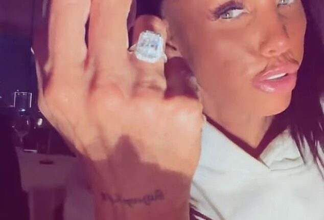 Katie Price has flashed her huge engagement ring as she kissed her new fiancé Lee Andrews after he popped the question whilst they holiday in Dubai