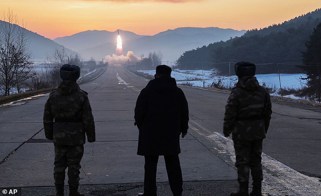 In this photo provided by the North Korean government, leader Kim Jong Un, center, inspects test-flights of hypersonic missiles, in Pyongyang, North Korea