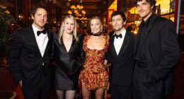 A body language expert has claimed Tom Ackerley made a 'cry for help' in an awkward snap with wife Margot Robbie and Jacob Elordi (L-R Tom, Emerald Fennell, Margot, Josey McNamara and Jacob)