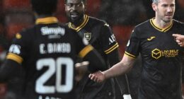 Jeremy Bokila, centre, looks on after being sent off in the game with Aberdeen at Pittodrie