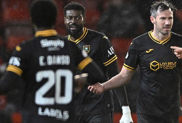 Jeremy Bokila, centre, looks on after being sent off in the game with Aberdeen at Pittodrie