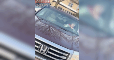 still of Renee Good driving her car from ICE agent's perspective