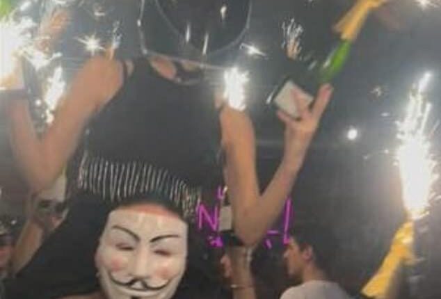 A photograph sent by survivors to French outlet BFMTV shows a waitress at Le Constellation sitting on the shoulders of a colleague while holding a sparkler in the air, moments before the deadly blaze ripped through the bar