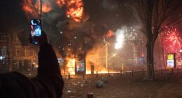 A tram stop is blown up with a makeshift explosive device as groups of residents from neighboring streets clash using fireworks in the Transvaal district on January 1, 2026 in The Hague