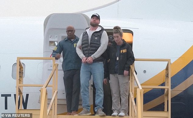 Pictured: Ryan Wedding in handcuffs after landing in the US following his arrest in Mexico City