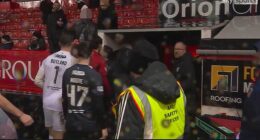 Nicolas Raskin, standing directly in front of red-shirted Aberdeen player at tunnel, appears to soak an Aberdeen supporter