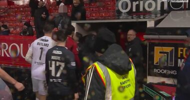Nicolas Raskin, standing directly in front of red-shirted Aberdeen player at tunnel, appears to soak an Aberdeen supporter