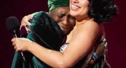 Pictured: Raye seen hugging her emotional grandmother Agatha Dawson as she wins Album of the Year at last night's BRIT Awards