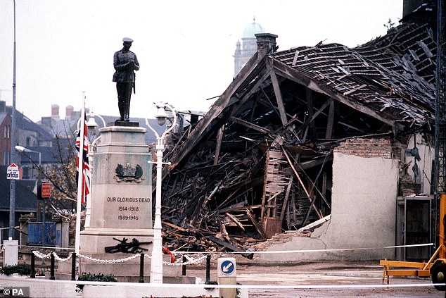 The cenotaph at Enniskillen with the devastated community centre in the background after the bombing