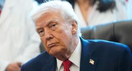 Trump signs an executive order in the Oval Office in the White House on December 18