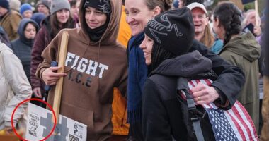 Seattle's liberal new mayor has been caught posing for a photograph with a far-left activist holding a placard calling for arson attacks against their political enemies, as shown above