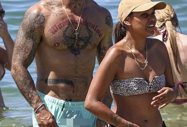 Spanian (left) accidentally gave onlookers an eyeful when his boardshorts turned see-through unexpectedly during a swim at Balmoral Beach with his girlfriend Ava Jean Walker (right)