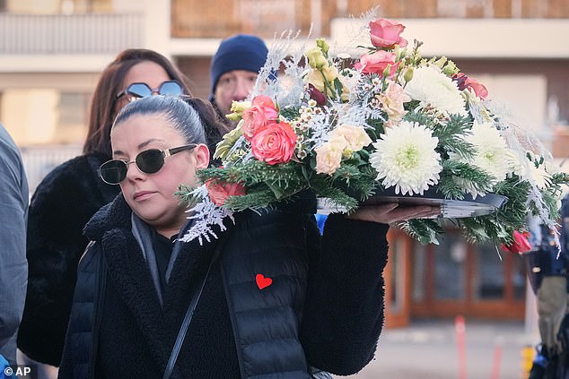 Families gathered and laid tributes at the scene where 40 people were killed following the fire at Le Constellation bar in Crans-Montana, Switzerland