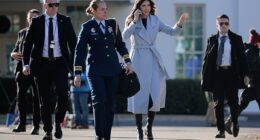 U.S. Secretary of Homeland Security Kristi Noem is accompanied by security agents as she walks out of the White House on January 15, 2026