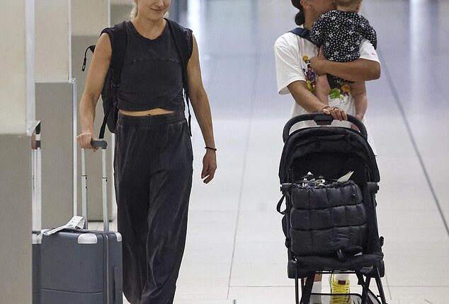 Sam Kerr shared a tender moment with son Jagger as she and wife Kristie Mewis flew out of Perth after their wedding on New Year's Eve