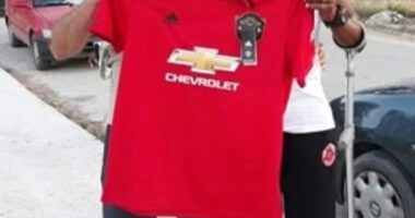 A man managed to dupe an entire Greek island that he was the legendary Manchester United player Remi Moses. Here he is pictured with a fan holding a United shirt in Zakynthos