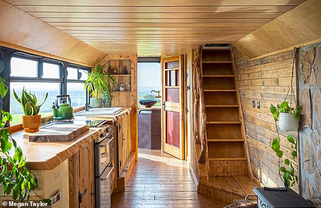 The walls and ceilings throughout are insulated and clad with reclaimed palette wood. The staircase banister is made from felled tree branches whittled by Jasmin and Bertie.