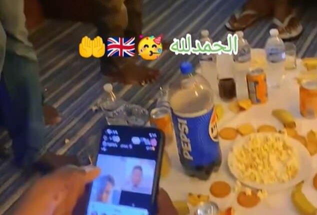 Suspected migrants have shared a video of themselves eating food at a social gathering in what is suspected to be temporary accommodation in Britain
