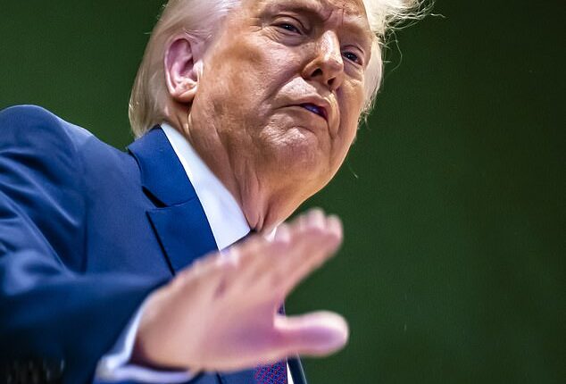 Donald Trump gestures as he climbs a staircase after a signing ceremony of the founding charter at the 'Board of Peace' meeting at Davos on January 22