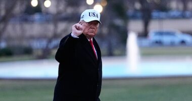 President Donald Trump gestures as he walks from Marine One after arriving on the South Lawn of the White House, Tuesday, Jan. 13, 2026, in Washington