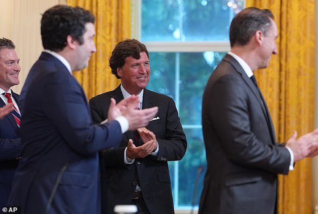 Tucker Carlson clapped at President Donald Trump entered the East Room of the White House for a press conference on Venezuelan Oil on Friday
