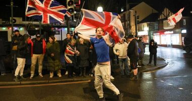 Photos show protesters gathered on Crowborough's High Street last night, holding England and Union Jack flags