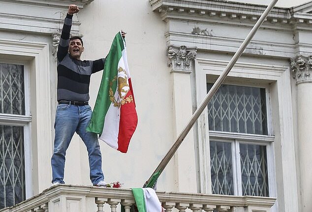 In London on Saturday a male protester was seen climbing onto the balcony of the Iranian embassy in Kensington and tearing down the flag of the current regime