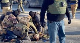 Border Force troops surround the motionless body of Pretti after he was killed in Minneapolis on Saturday