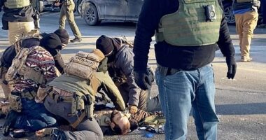 Border Force troops surround the motionless body of Pretti after he was killed in Minneapolis on Saturday