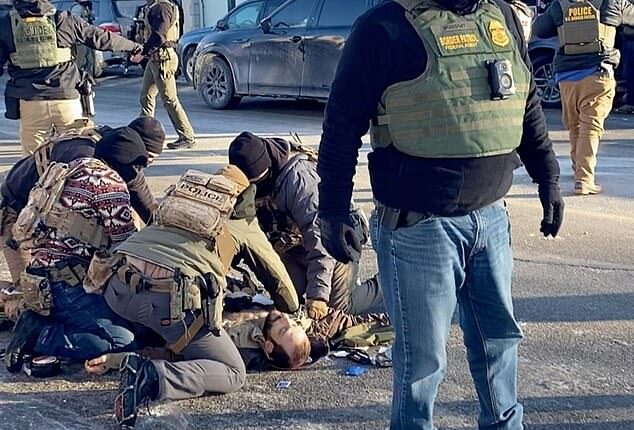 Border Force troops surround the motionless body of Pretti after he was killed in Minneapolis on Saturday