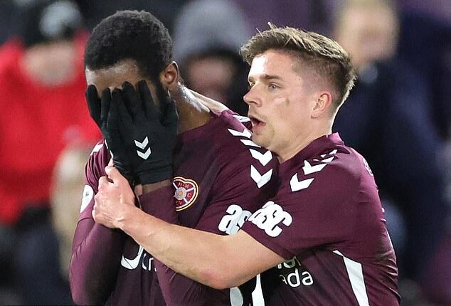 Baningime, above left, was distraught after red card but Hearts still went on to win game