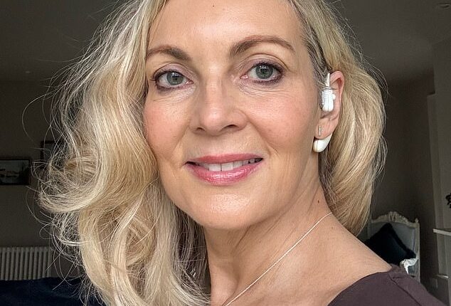 Alice Smellie with her Sona – a vagus nerve-stimulating earpiece – which she believes has given her a calmer outlook