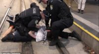 Footage has emerged of a man pinned to the light rail tracks on George Street by police