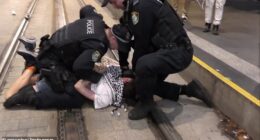 Footage has emerged of a man pinned to the light rail tracks on George Street by police