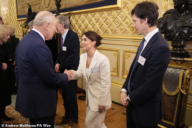 Coleen Rooney cut a sophisticated figure in a cream pinstripe suit as she greeted King Charles during a reception highlighting the inspirational work of paid and unpaid carers at Windsor Castle on Wednesday