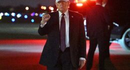 US President Donald Trump makes a fist after he steps off Air Force One upon arrival at Palm Beach