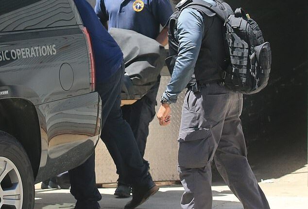 Prison guards are alleged to have used a decoy body to distract reporters gathered outside the jail as Epstein’s body was transferred to the Office of the Chief Medical Examiner. This image shows his body being removed from a Lower Manhattan hospital, where he was pronounced dead