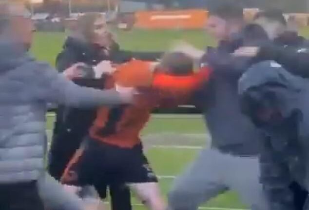 A Bilston Town player appeared to become embroiled in a fight with fans on Saturday evening