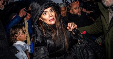 Furious families ATTACK owners of Swiss inferno nightclub where youngsters burned to death: Terror is etched on female manager's face as parents scream 'you killed my son - you'll pay for this'