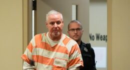 The trial of Colin Gray, a Georgia father accused of gifting his son a rifle before a school shooting in 2024, began on Monday. Colin is pictured entering a courtroom at an earlier date