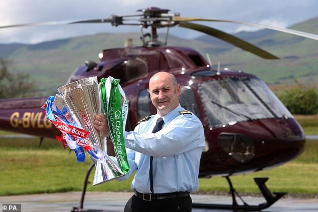 Pilot David Young prepares to deliver the Premiership trophy back in 2009 season but will a helicopter be needed on the final day of this season?