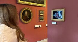 On Sunday, activists hung a photo of Andrew Mountbatten-Windsor following his arrest (pictured) at the Louvre museum in Paris