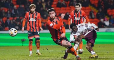 Kabore nets Hearts' third goal in a rout of nine-man Dundee Utd at Tannadice