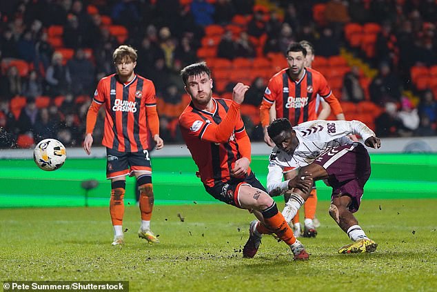 Kabore nets Hearts' third goal in a rout of nine-man Dundee Utd at Tannadice