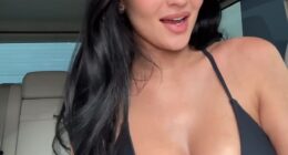 Kylie Jenner, 28, put on a sultry display in a plunging sports bra as she posed up a storm with BFF Stassie Karanikolaou and plugged products from her makeup brand