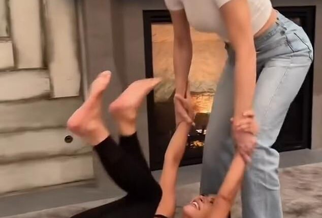 Lewis Hamilton enjoyed a family night in with Kim Kardashian and her sisters with his voice heard in the background of a hilarious home video shared by Kim on Monday